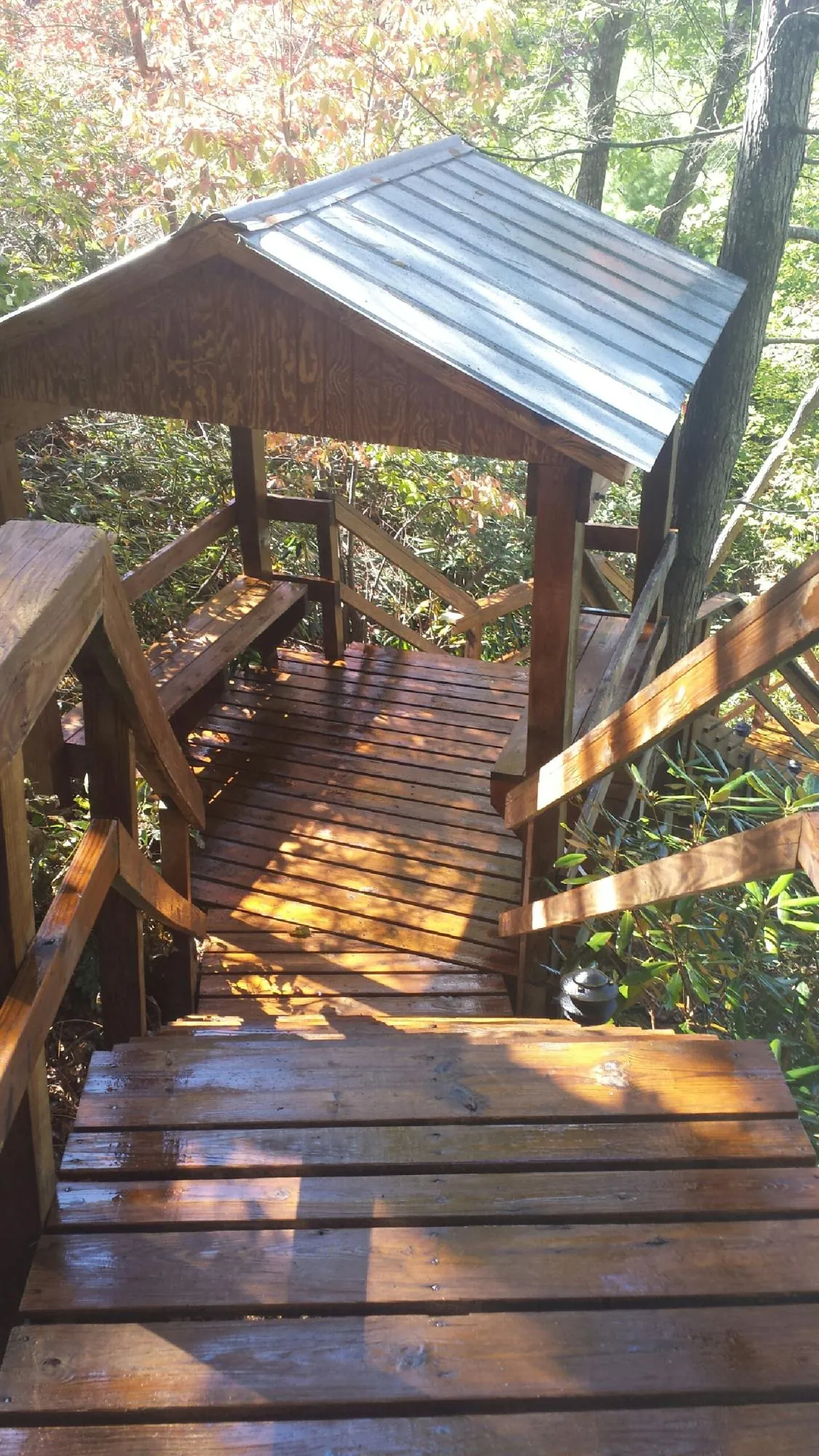 Freshly stained wood walkway and covered shelter with a metal roof in Camden